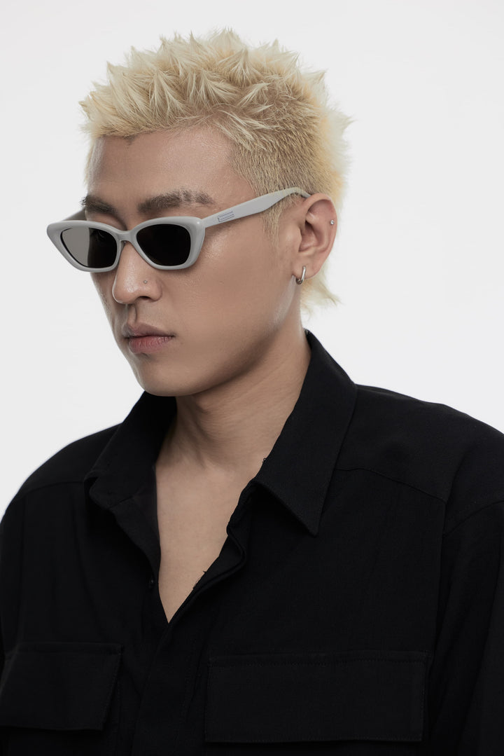 Model of his side face looking down wearing California in grey cat-eye Korean Fashion Sunglasses from Mercury Retrograde Burr Puzzle Collection 