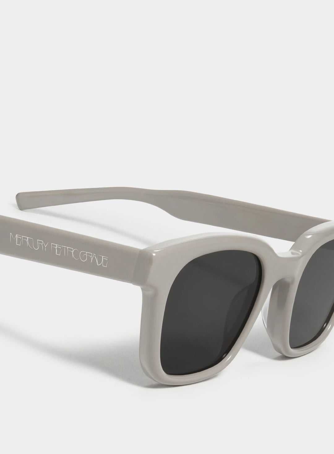 Close-up of Bubblegum in grey square Sunglasses lenses, stylish eyewear by Mercury Retrograde Daydream Collection 
