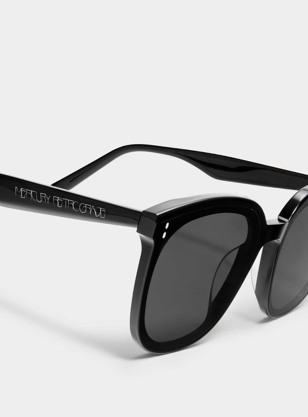 Close-up of Manta in black square Sunglasses lenses, high-quality eyewear by Mercury Retrograde Burr puzzle Collection 