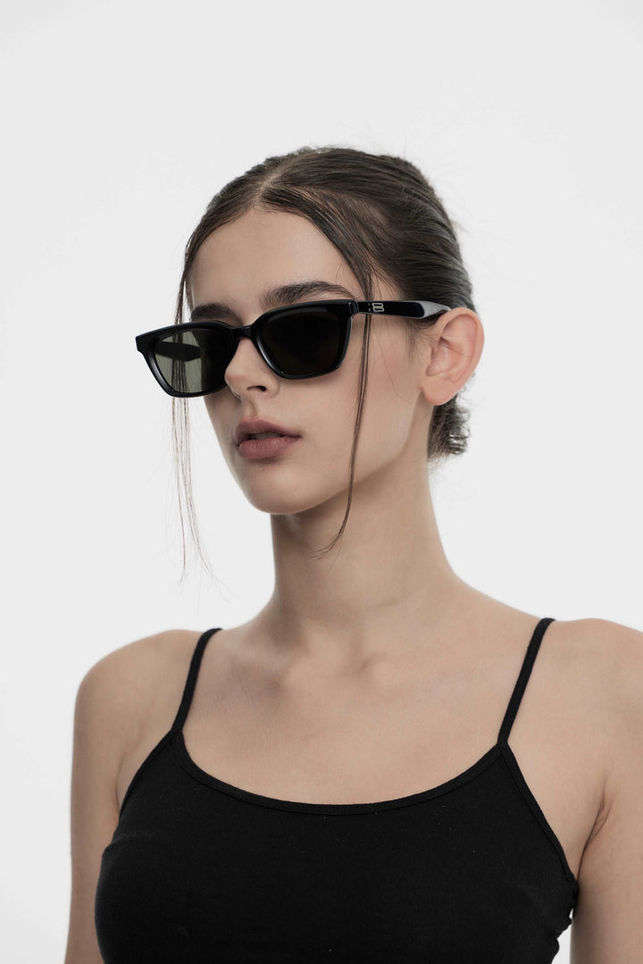 Model wearing Shadow in black square Designer Sunglasses from Mercury Retrograde Burr Puzzle Collection 