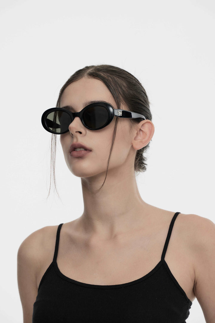 Model of her side face looking up wearing Artist Korean Fashion Poison in black round Sunglasses from Mercury Retrograde Burr Puzzle Collection 