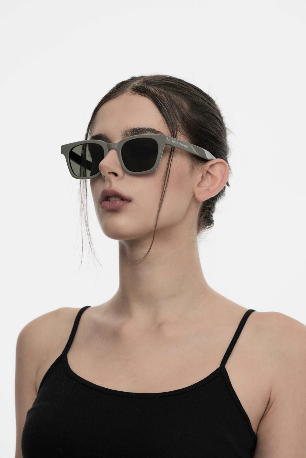 Model of her side face looking down wearing Bubblegum in grey Korean Fashion square Sunglasses from Mercury Retrograde Daydream Collection 