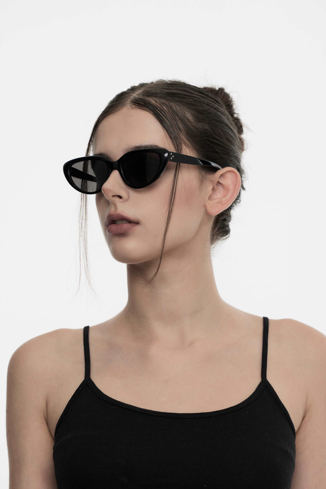 Side profile of female model wearing Daydream’s BEBE black Sunglasses from Mercury Retrograde Designer Eyewear