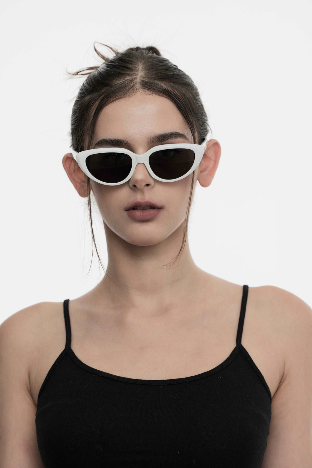 Female Model of her front face wearing Daydream’s BEBE in white Fashionable sunglasses from Mercury Retrograde