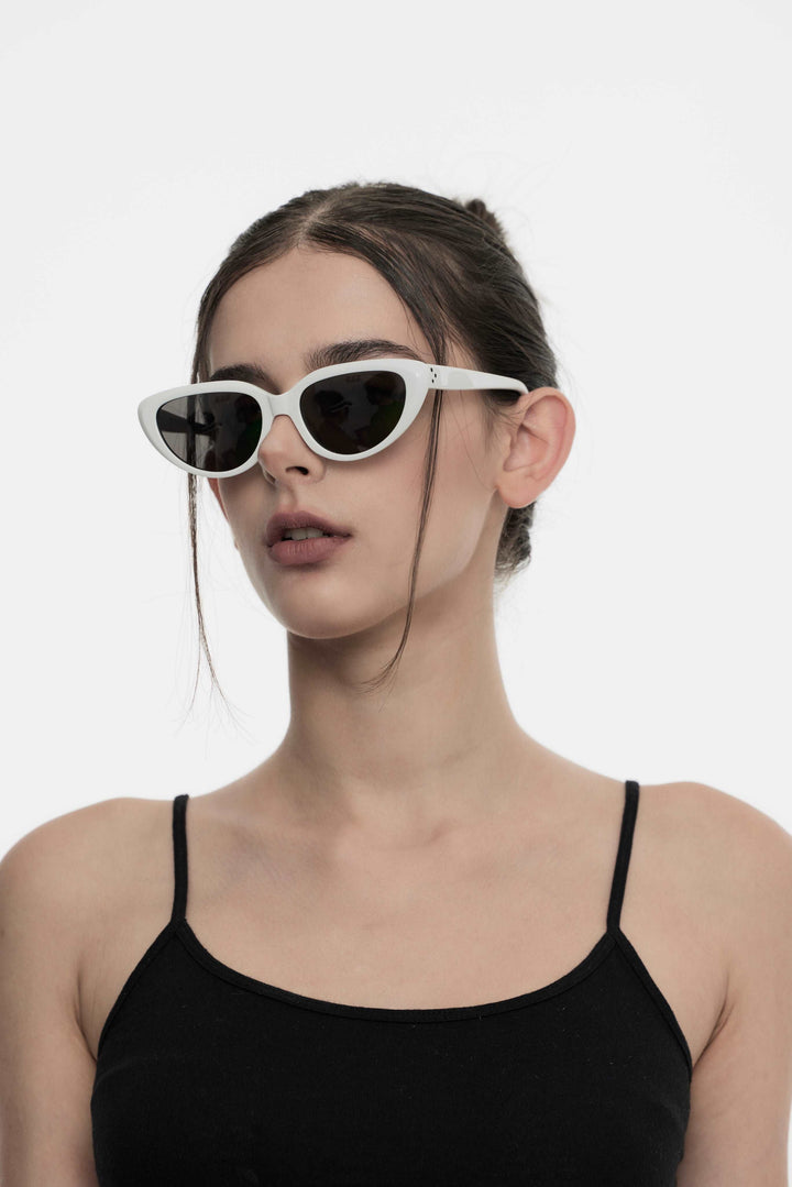 Side portrait of model illustrating the trendy design of Daydream’s BEBE in white Sunglasses with UV protection by Mercury Retrograde