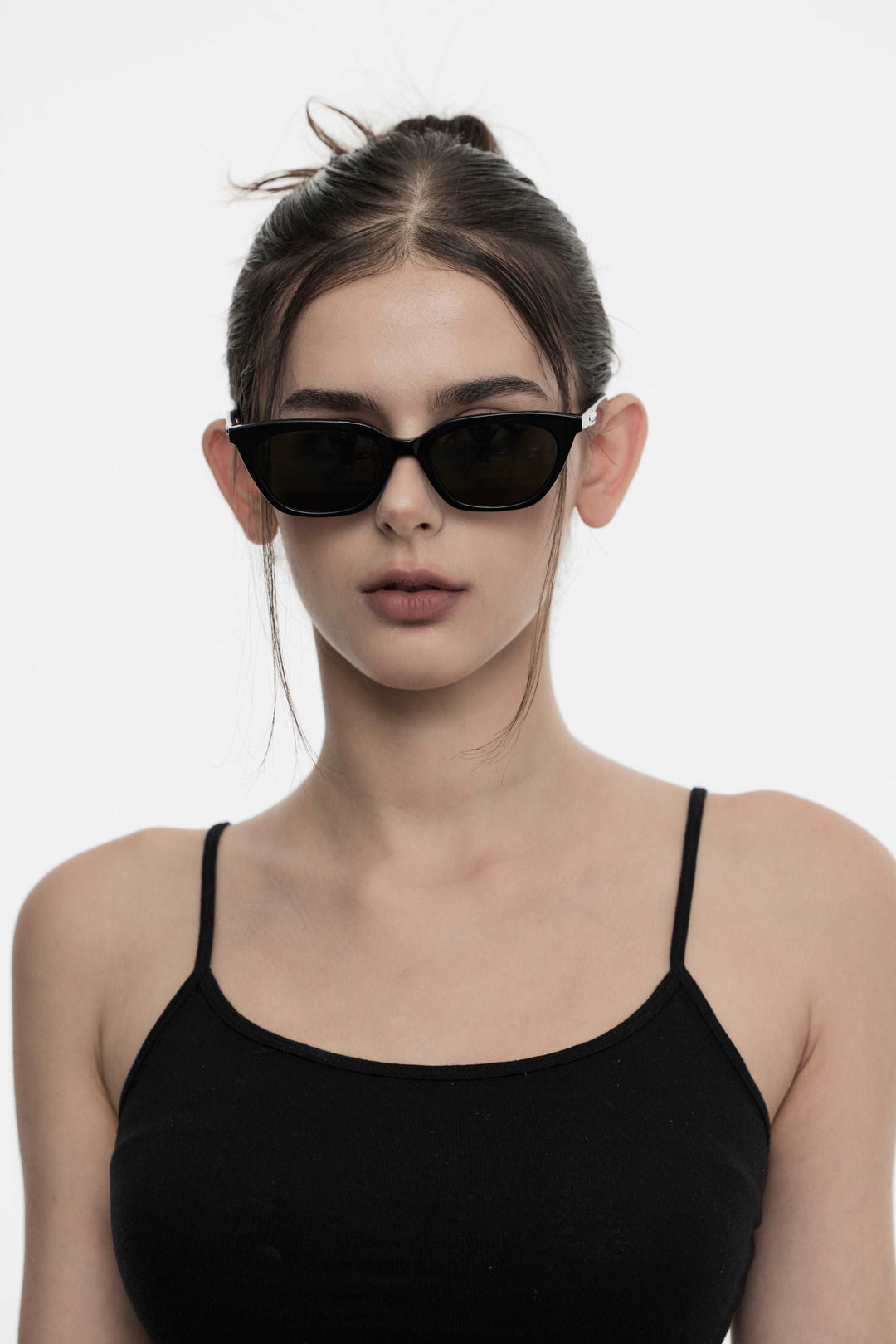 Female Model of her front face wearing Lust in black cat-eye trendy sunglasses from Mercury Retrograde Burr Puzzle Collection 