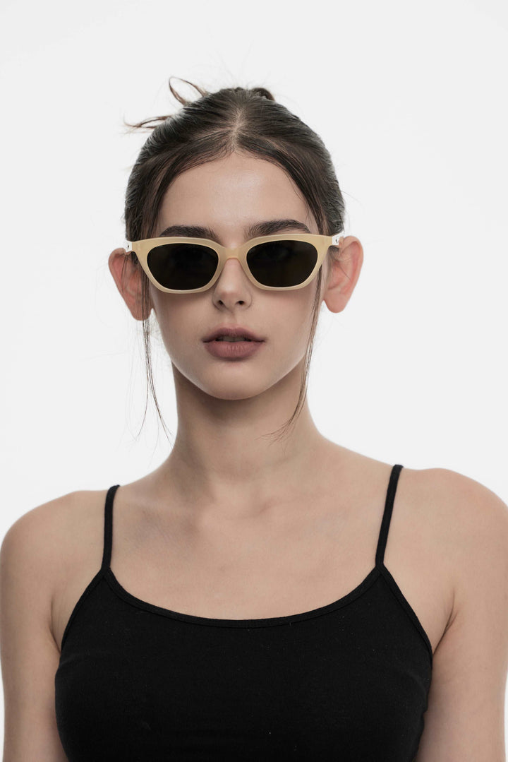 Female Model of her front face wearing Lust in yellow cat-eye stylish sunglasses from Mercury Retrograde Burr Puzzle Collection 