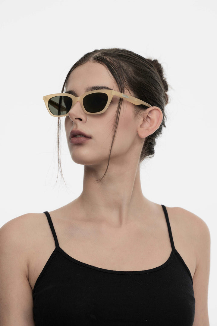 Model of her side face looking up wearing Lust in yellow cat-eye Kpop Sunglasses from Mercury Retrograde Burr Puzzle Collection 
