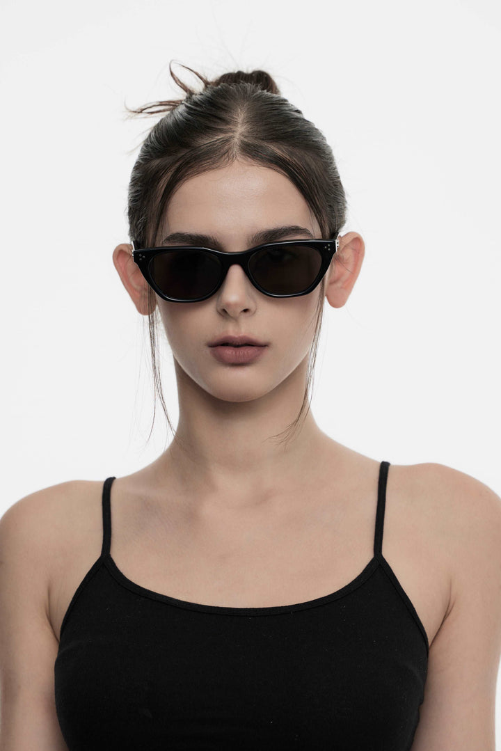 Female Model of her front face wearing Artist trendy Dex in black cat-eye sunglasses from Mercury Retrograde Burr Puzzle Collection 
