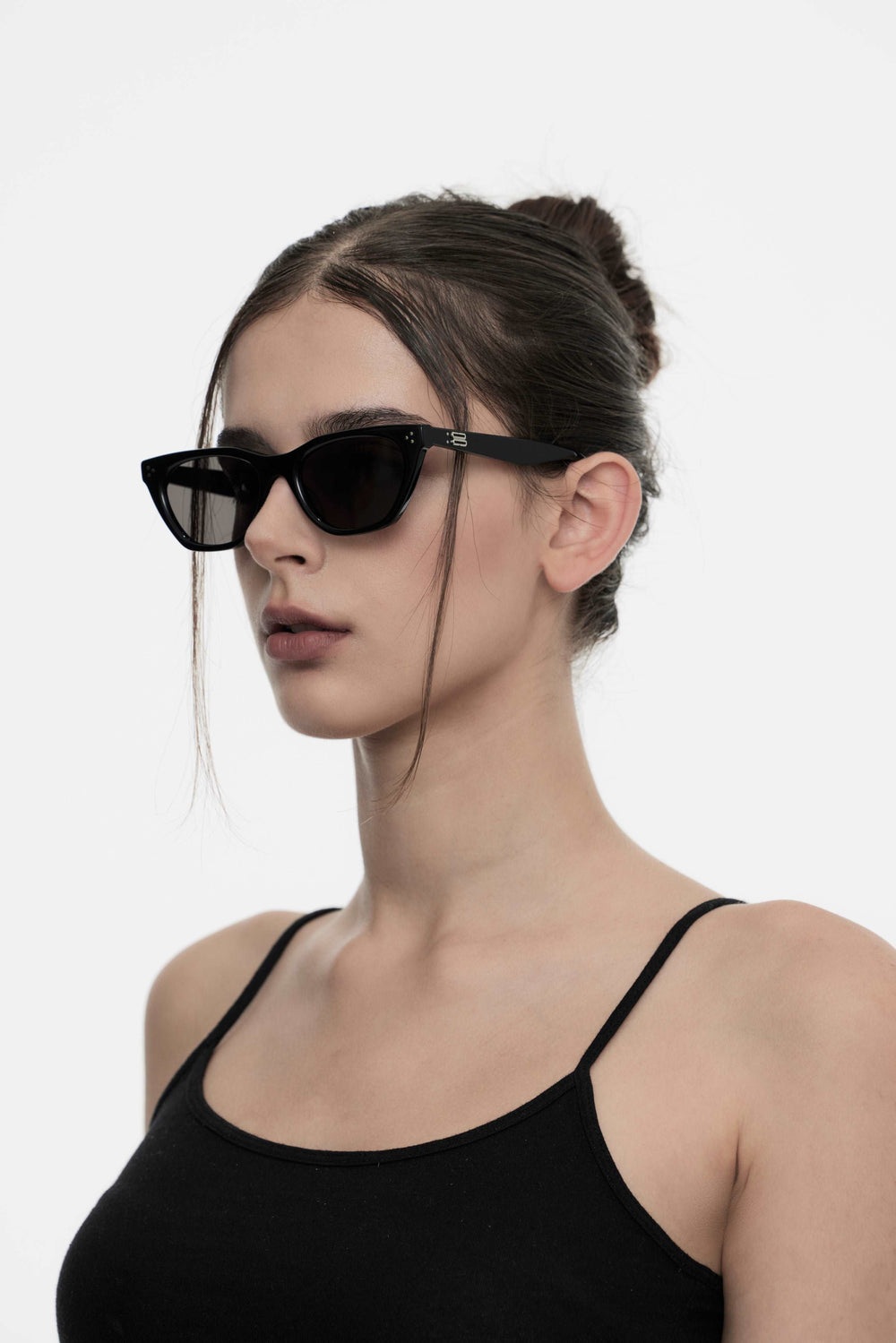 Model showcasing side view of Lust Korean Fashion Dex in black cat-eye Sunglasses from Mercury Retrograde's Burr Puzzle Collection
