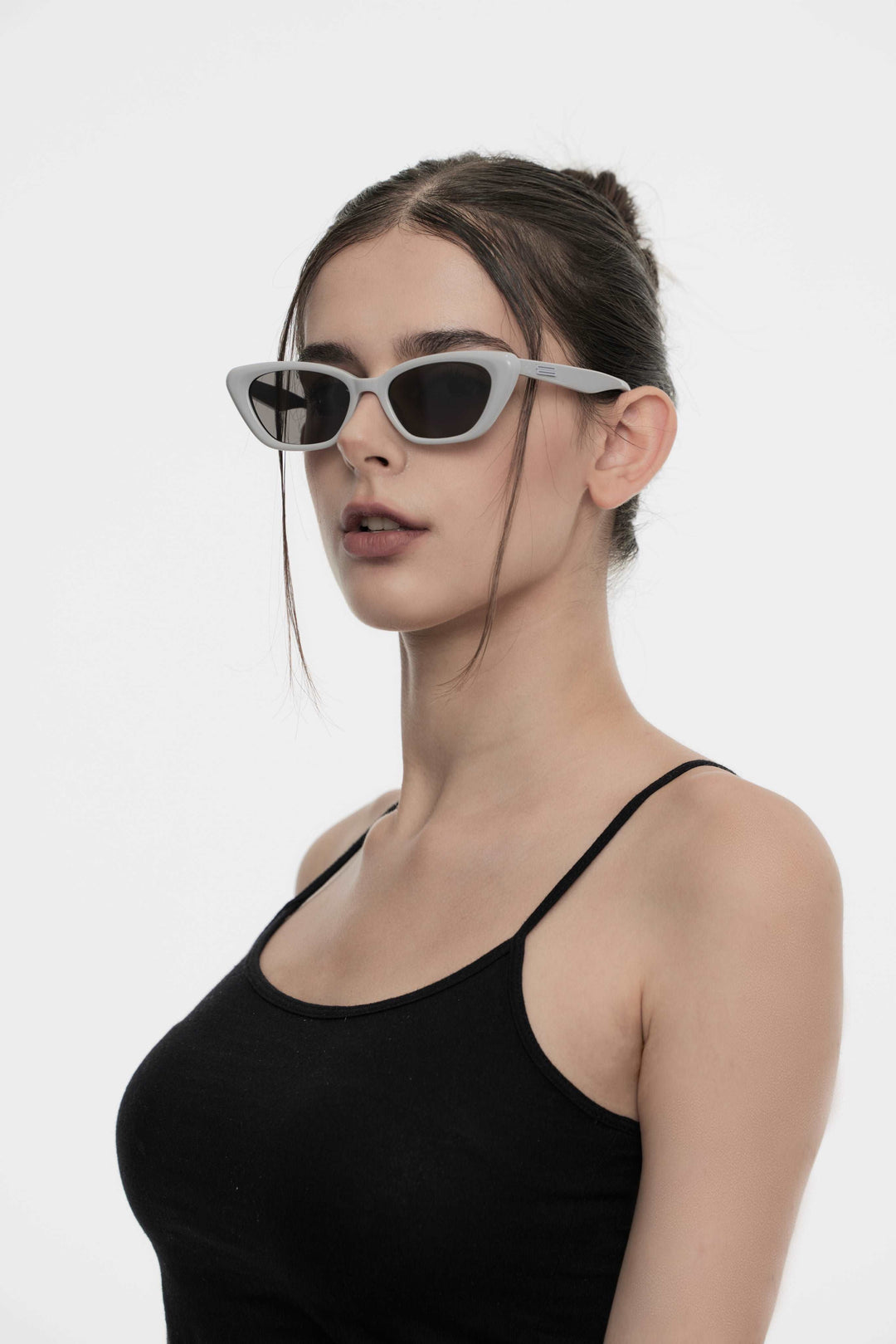 Model showcasing side view of Lust Korean Fashion California in grey cat-eye Sunglasses from Mercury Retrograde's Burr Puzzle Collection