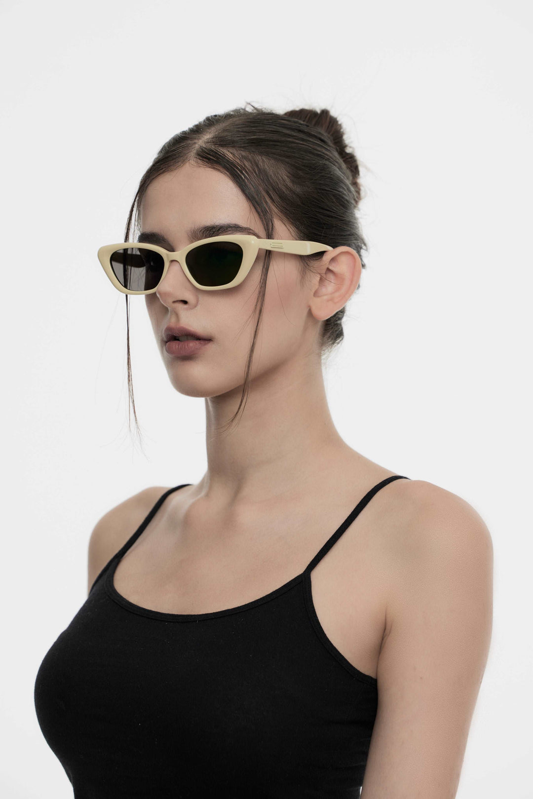 Model showcasing side view of Lust Korean Fashion California in mayo yellow cat-eye Sunglasses from Mercury Retrograde's Burr Puzzle Collection
