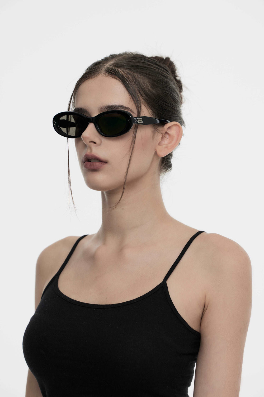 Model of her side face wearing Burr Puzzle’s Breath in black Kpop Sunglasses from Mercury Retrograde