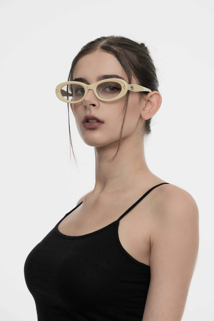Model wearing her Burr Puzzle’s Breath in light yellow stylish round Sunglasses from Mercury Retrograde