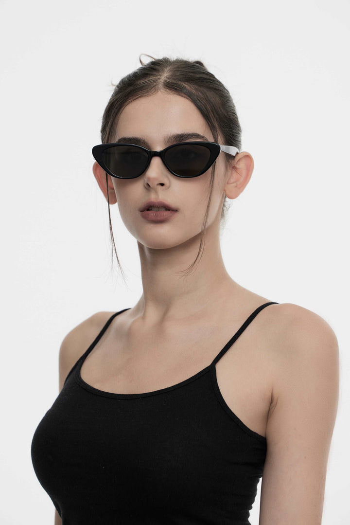Model wearing Dawn in black cat-eye Designer Sunglasses from Mercury Retrograde Daydream Collection 