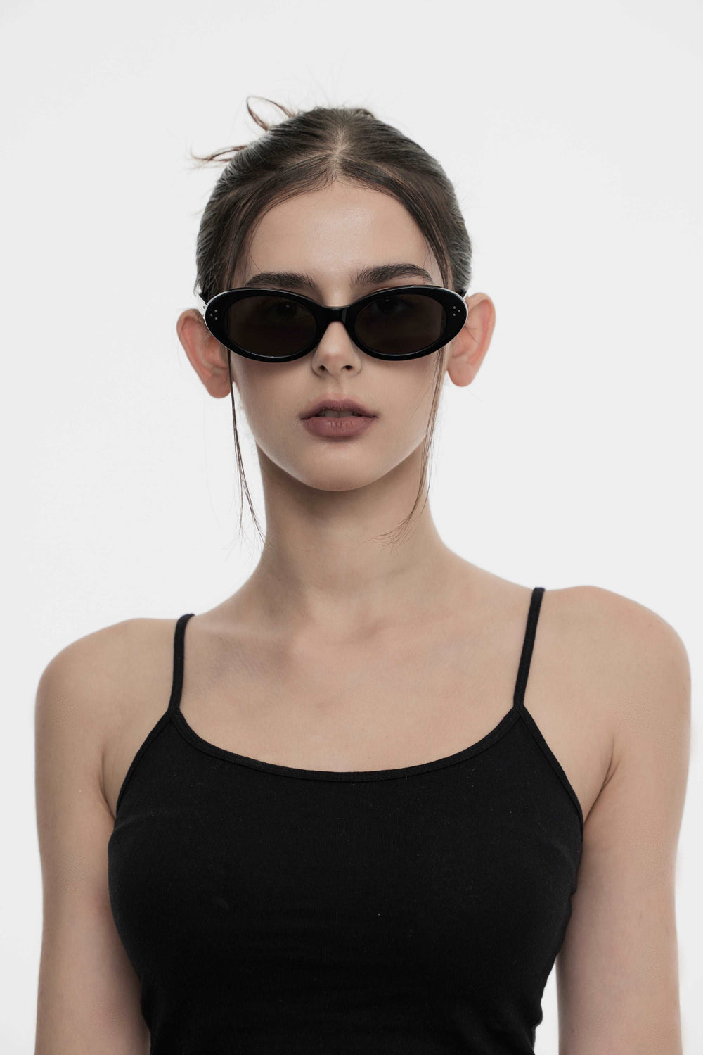 Female Model of her front face wearing Wave in black round trendy sunglasses from Mercury Retrograde Burr Puzzle Collection 