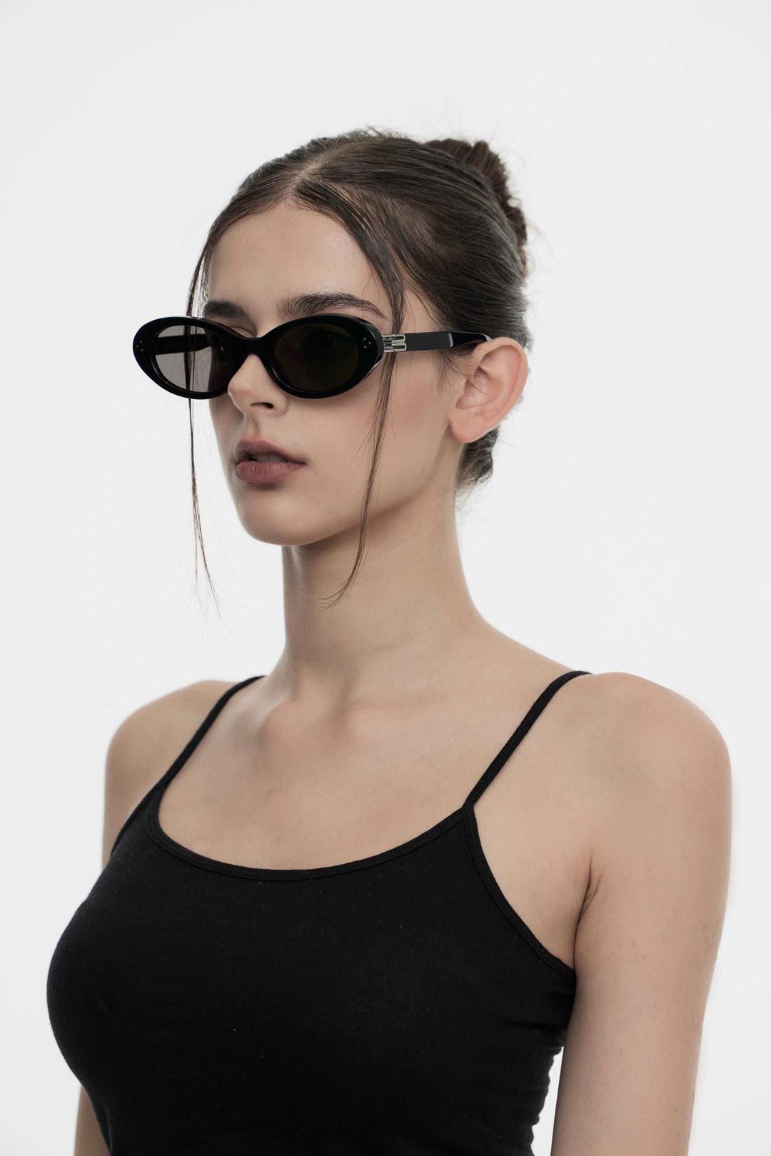 Model showcasing side view of Lust Korean Fashion Wave in black round Sunglasses from Mercury Retrograde's Burr Puzzle Collection
