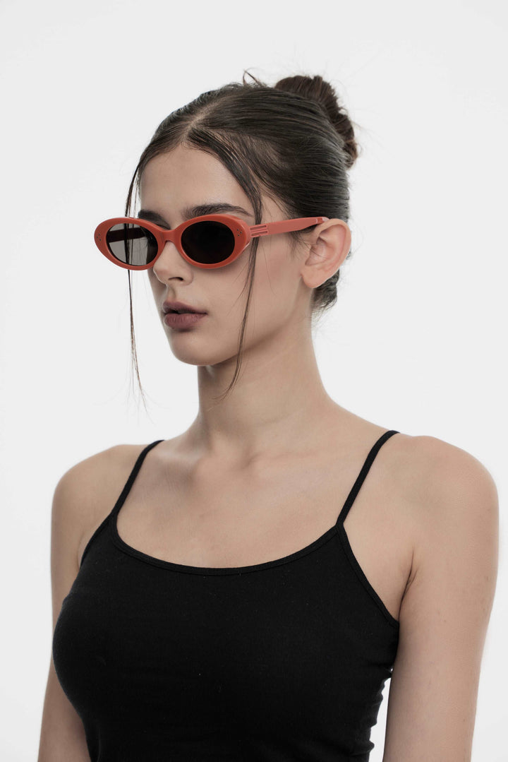 Model showcasing side view of Lust Korean Fashion Wave in red round Sunglasses from Mercury Retrograde's Burr Puzzle Collection