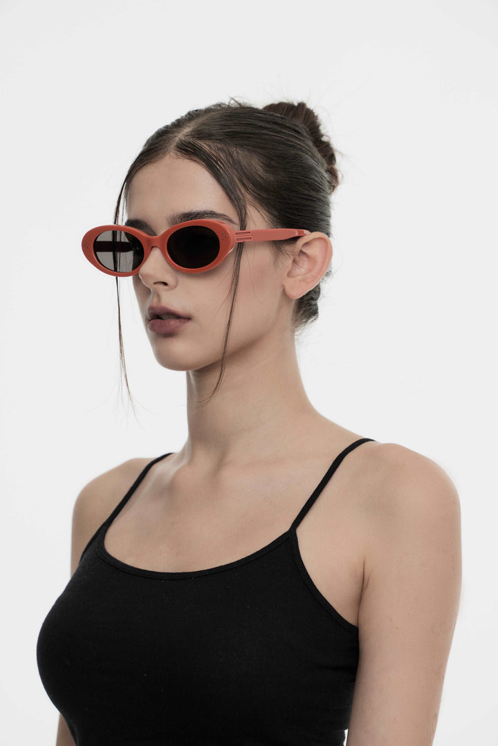 Side portrait of model illustrating the stylish design of Burr Puzzle's Wave in red round Sunglasses by Mercury Retrograde