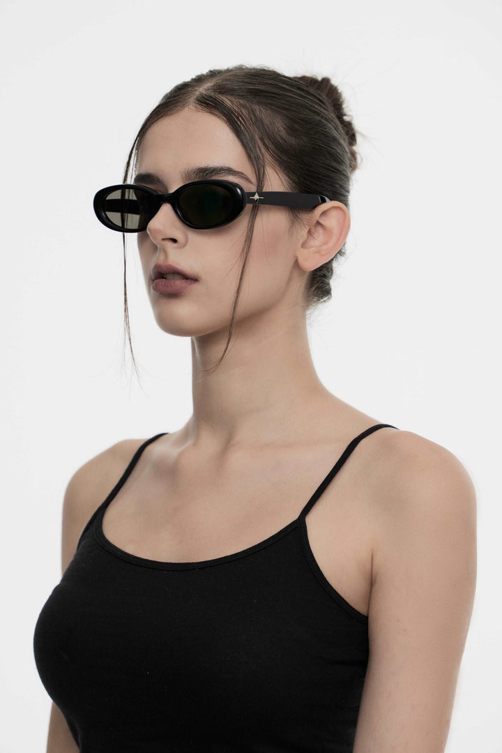 Model showcasing side view of Lust Korean Fashion Crux in black round Sunglasses from Mercury Retrograde's Galaxy Collection