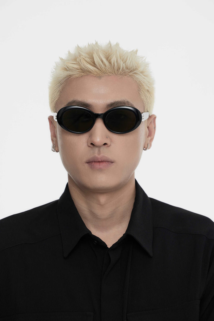 Male Model of his front face wearing Poison in black round fashion sunglasses from Mercury Retrograde Burr Puzzle Collection 