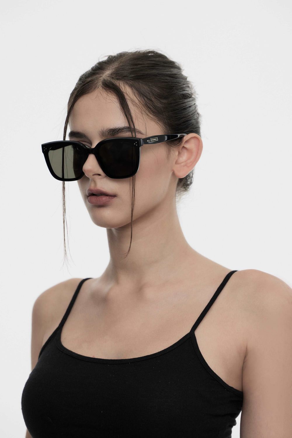Model showcasing side view of Lust Korean Fashion Indulge in black square Sunglasses from Mercury Retrograde's Burr Puzzle Collection