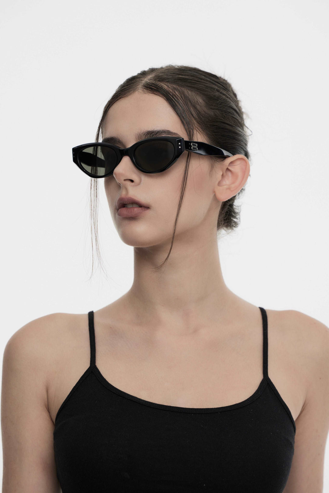 Side profile of model wearing trendy Symphony in black cat-eye Sunglasses from Mercury Retrograde Burr Puzzle Collection 