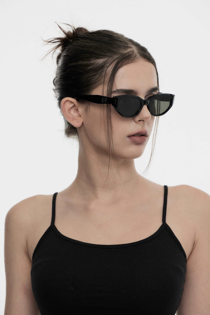 Model wearing Symphony in black cat-eye Designer Sunglasses from Mercury Retrograde Burr Puzzle Collection 