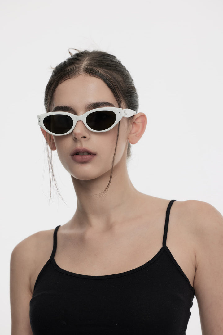 Female Model of her front face wearing Symphony in white cat-eye trendy sunglasses from Mercury Retrograde Burr Puzzle Collection 