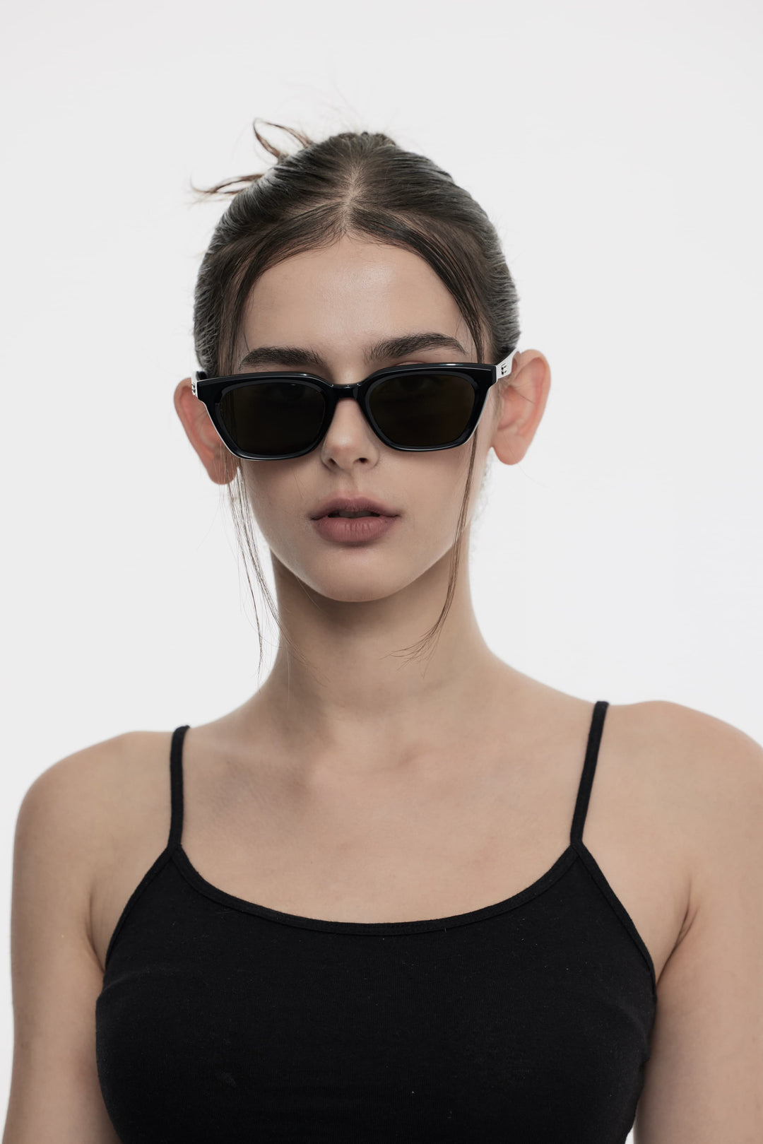 Female Model of her front face wearing Burr Puzzle’s Shadow in black square stylish sunglasses from Mercury Retrograde