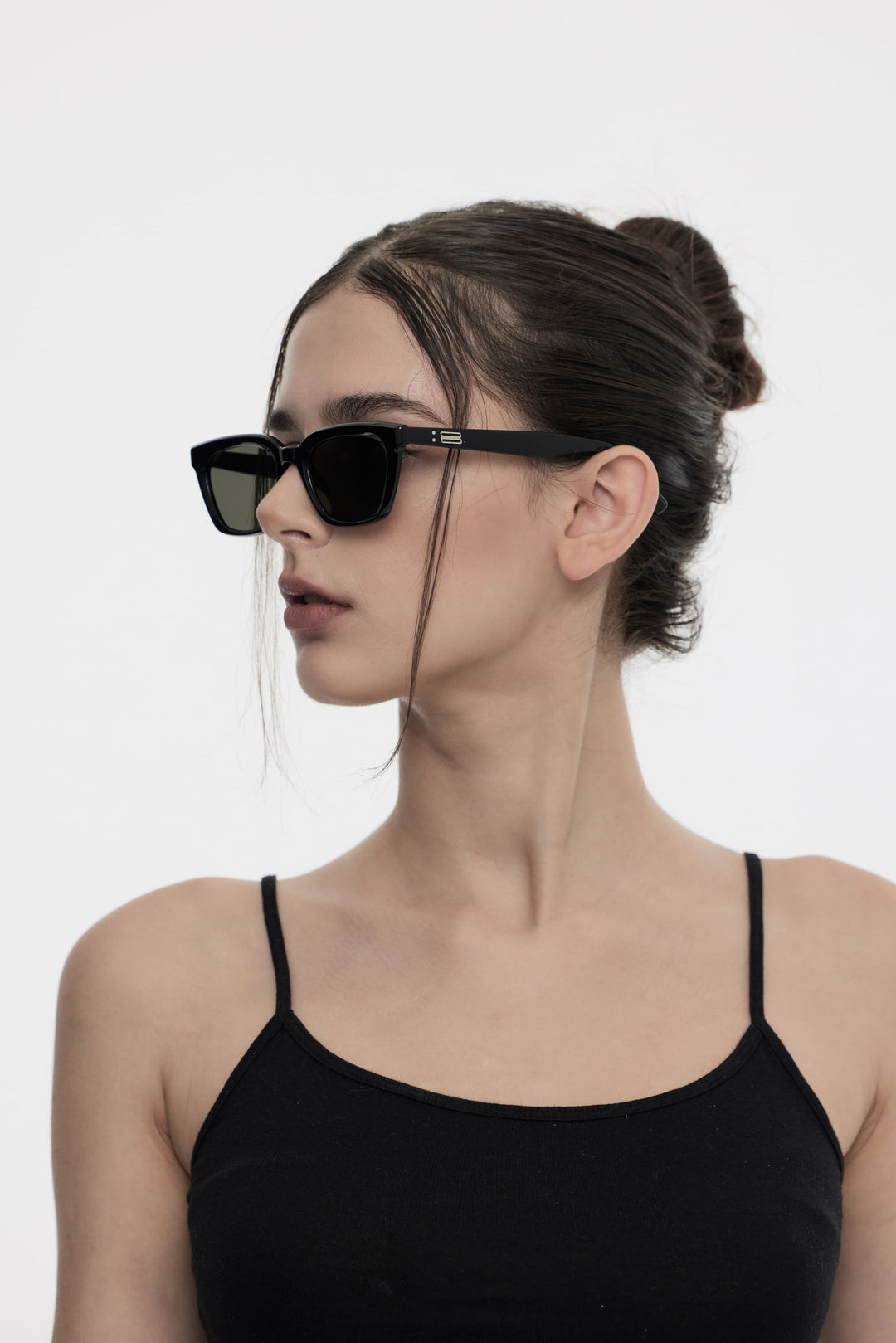 Side portrait of model illustrating the stylish design of Burr Puzzle's Shadow in black square Sunglasses by Mercury Retrograde