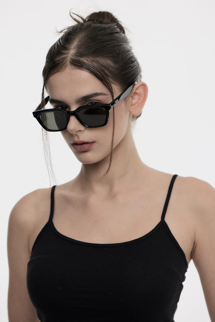 Model of her side face looking down wearing Burr Puzzle’s Shadow in black square Korean Fashion Sunglasses from Mercury Retrograde