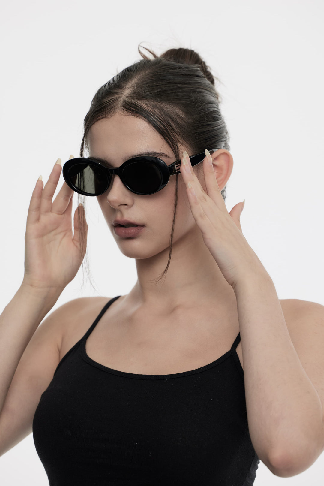 Model wearing Poison in black round Designer Sunglasses from Mercury Retrograde Burr Puzzle Collection 