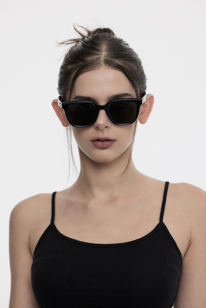 Female Model of her front face wearing Cygnus in black square sunglasses with UV protection from Mercury Retrograde Galaxy Collection 