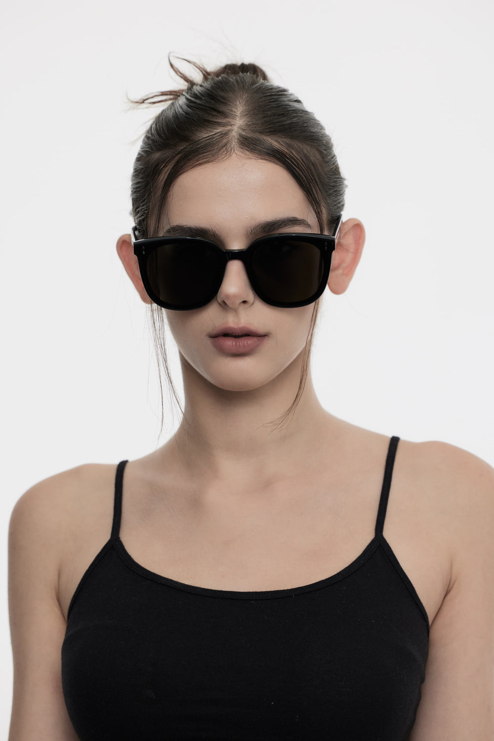 Female Model of her front face wearing Manta in black trendy square sunglasses from Mercury Retrograde Burr Puzzle Collection 