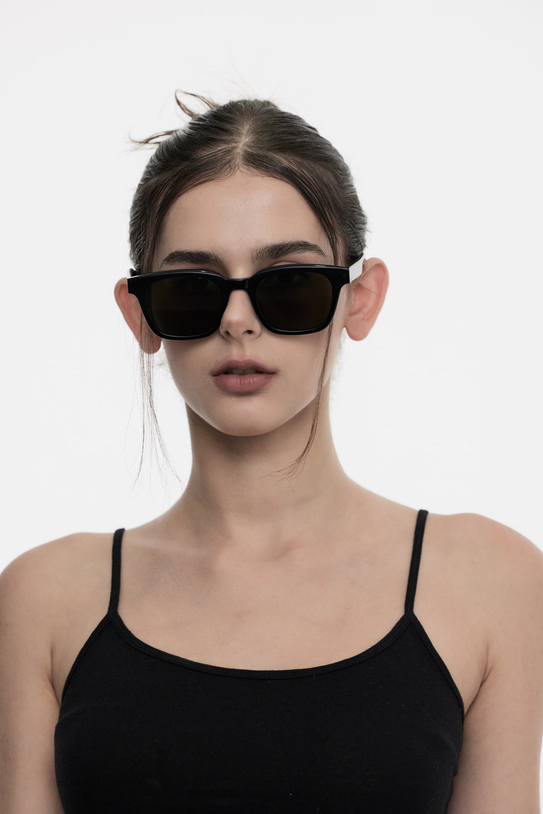 Female Model of her front face wearing Bubblegum in black trendy square sunglasses from Mercury Retrograde Daydream’s Collection 