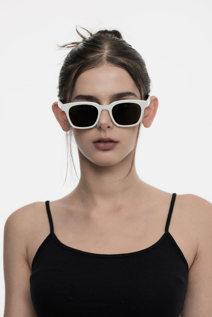 Female Model of her front face wearing Bubblegum in white square High-quality sunglasses from Mercury Retrograde Daydream Collections 