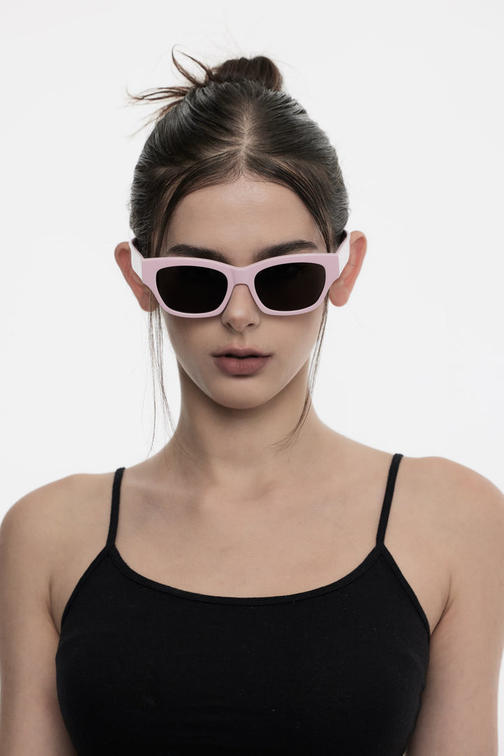 Female model wearing her Muse in pink square Designer Sunglasses from Mercury Retrograde Daydream Collection 