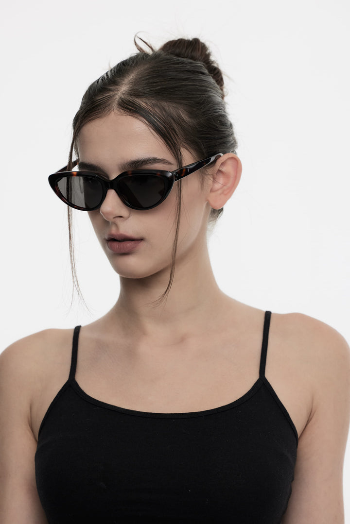 Model of her side face looking down wearing Daydream’s BEBE in tortoiseshell Korean Designer Sunglasses from Mercury Retrograde