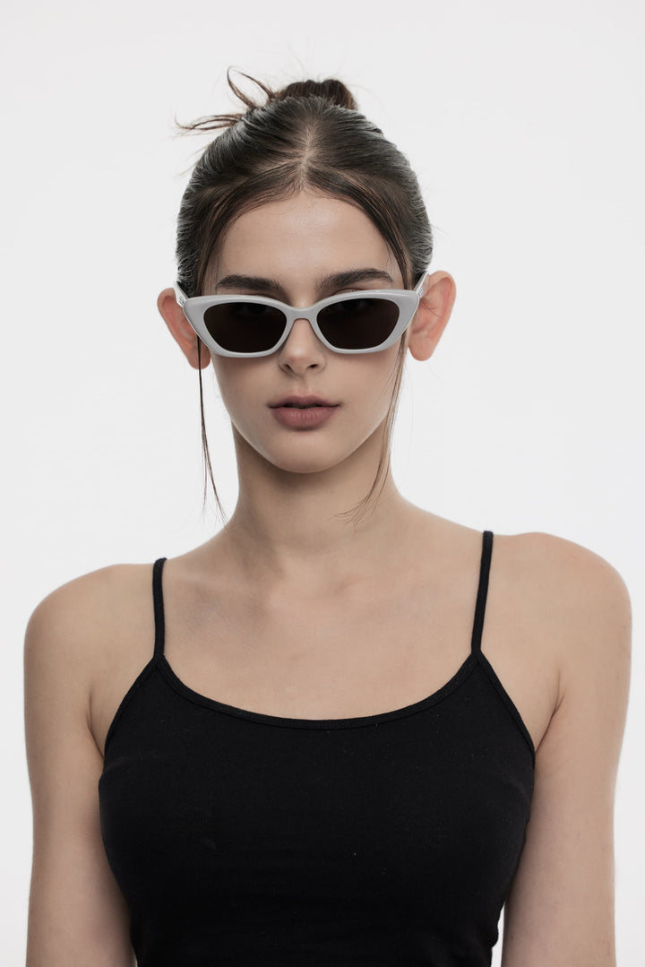 Female Model of her front face wearing California in grey cat-eye trendy sunglasses from Mercury Retrograde Burr Puzzle Collection 