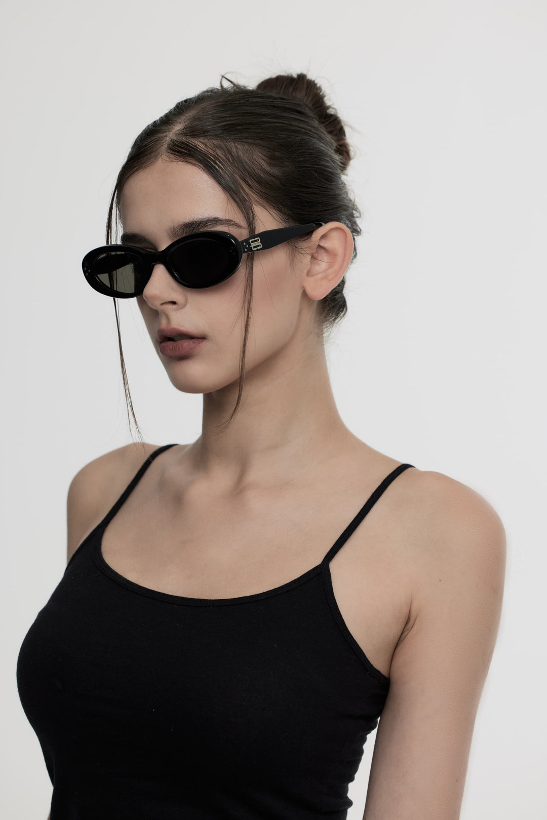 Side portrait of model illustrating the fashionable K-pop design of Burr Puzzle's Breath in black round Sunglasses by Mercury Retrograde