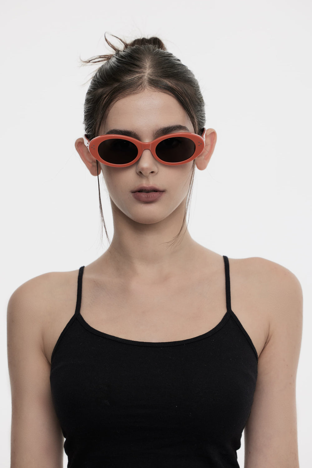 Female Model of her front face wearing Wave in red round stylish sunglasses from Mercury Retrograde Burr Puzzle Collection 