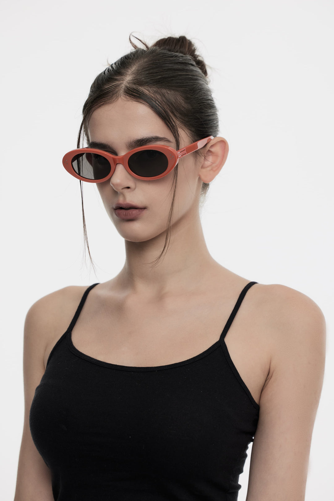 Model of her side face looking down wearing Wave in red round Kpop Sunglasses from Mercury Retrograde Burr Puzzle Collection 