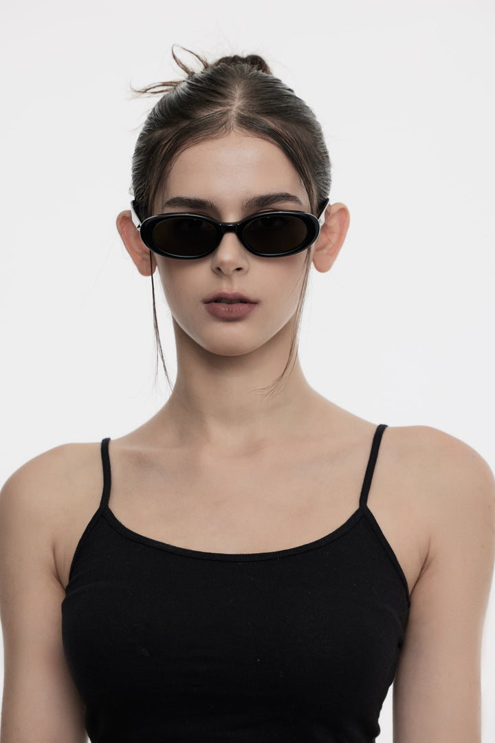 Female Model of her front face wearing Crux in black round stylish sunglasses from Mercury Retrograde Galaxy Collection 