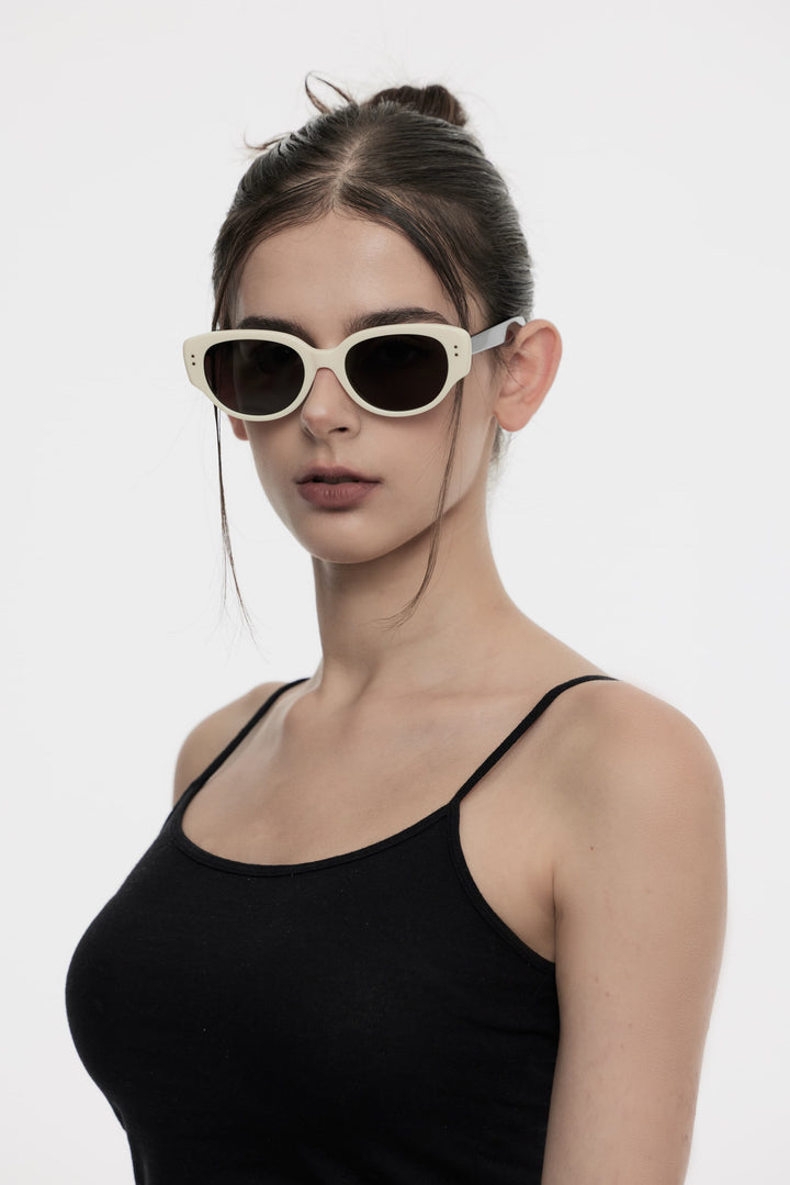 Model wearing Panda in black&white round Designer Sunglasses from Mercury Retrograde Daydream Collection 