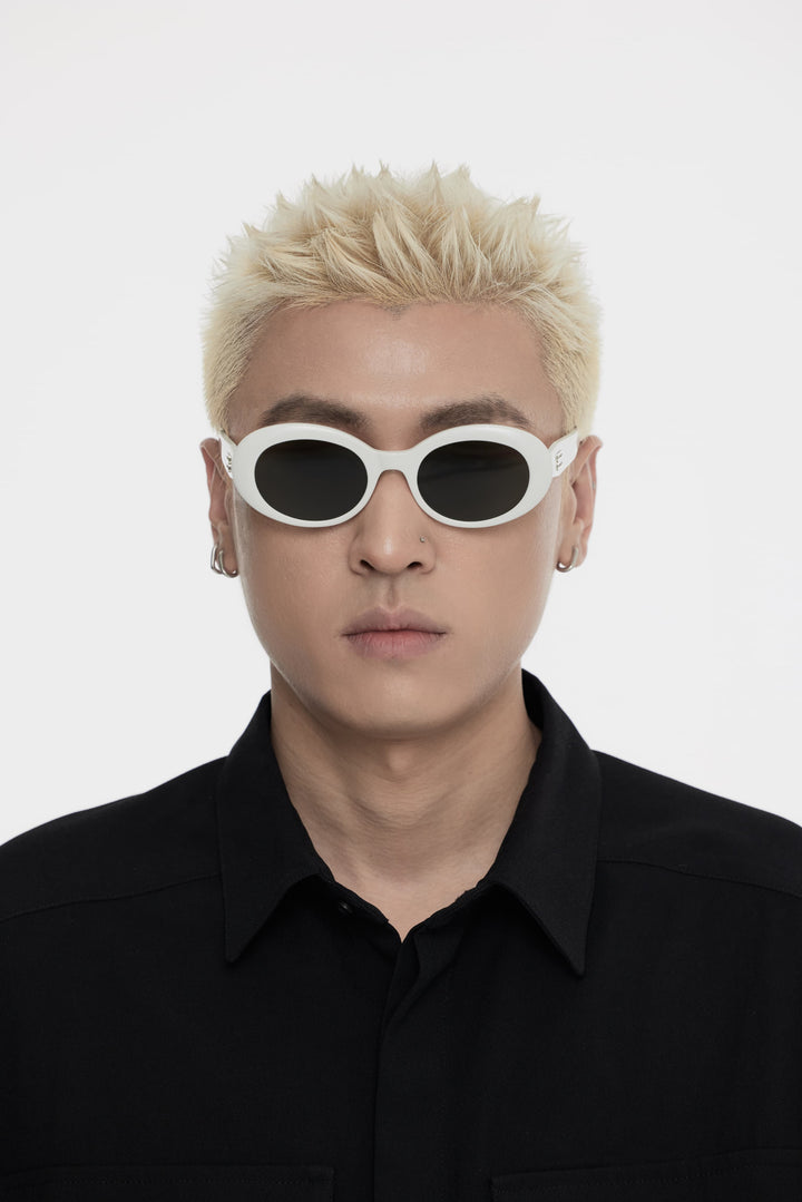 Male Model of his front face wearing Poison in white round fashion sunglasses from Mercury Retrograde Burr Puzzle Collection 