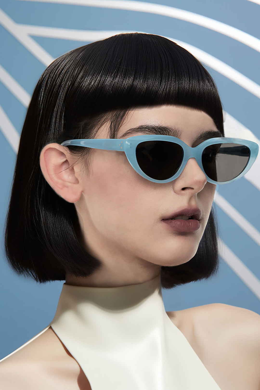 Chic model wearing blue-framed mercury retrograde sunglasses.