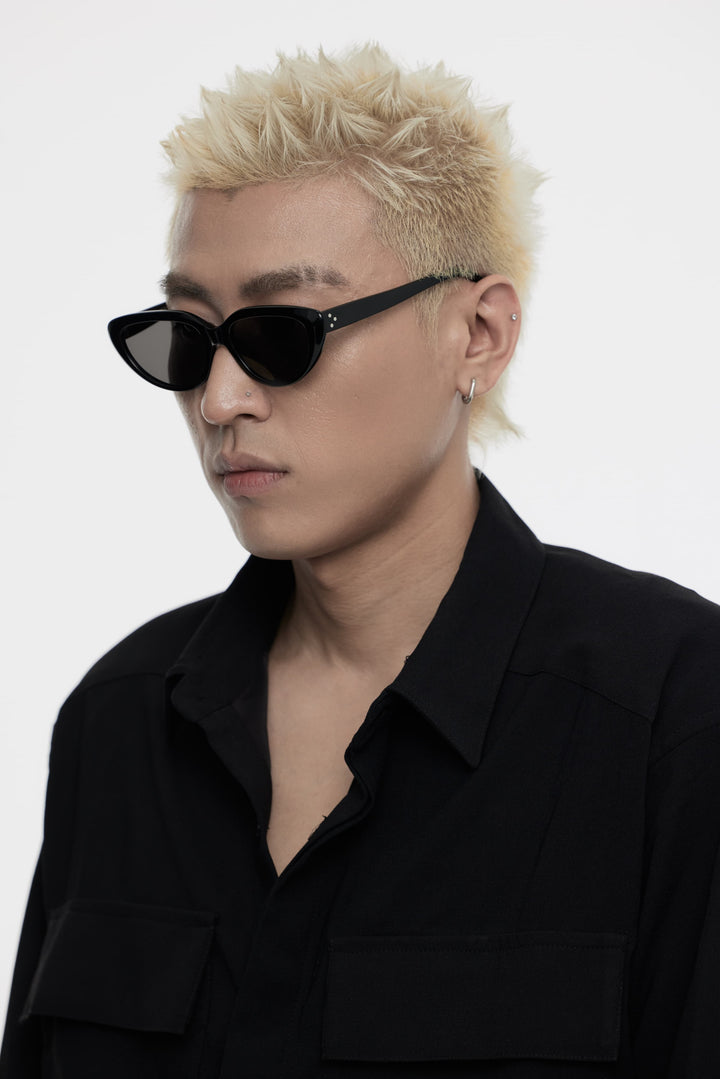 Side portrait of model illustrating the stylish design of Daydream's BEBE black Sunglasses by Mercury Retrograde Fashionable Eyewear