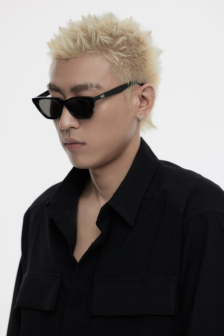 Model of his side face looking down wearing Dex in black cat-eye Korean Fashion Sunglasses from Mercury Retrograde Burr Puzzle Collection 