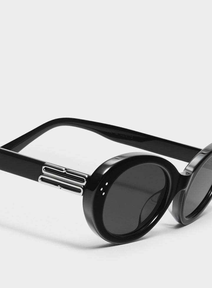 Close-up of Wave in black round Sunglasses lenses, high-quality eyewear by Mercury Retrograde Burr Puzzle Collection 